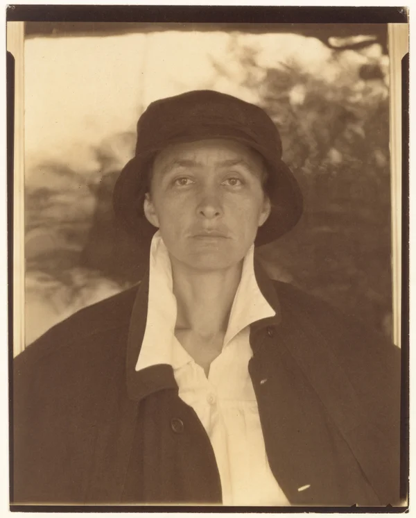 georgia-o-keeffe front-portrait-with-hat-and-coat-serious-face female