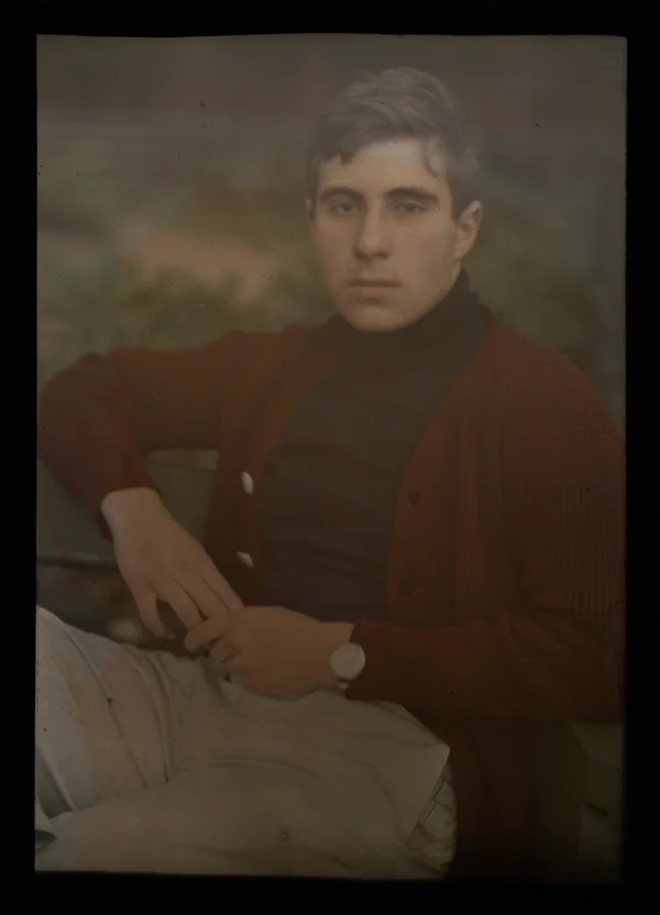 unknown man-in-red-sweater-sitting-in-a-park male