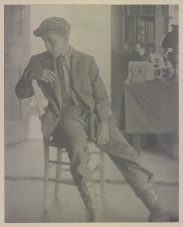 maynard-white-suit-boots-cap-seated male