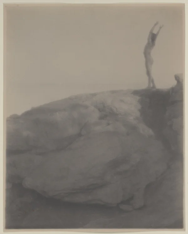nude-boy-rocky-landscape-arms-raised male