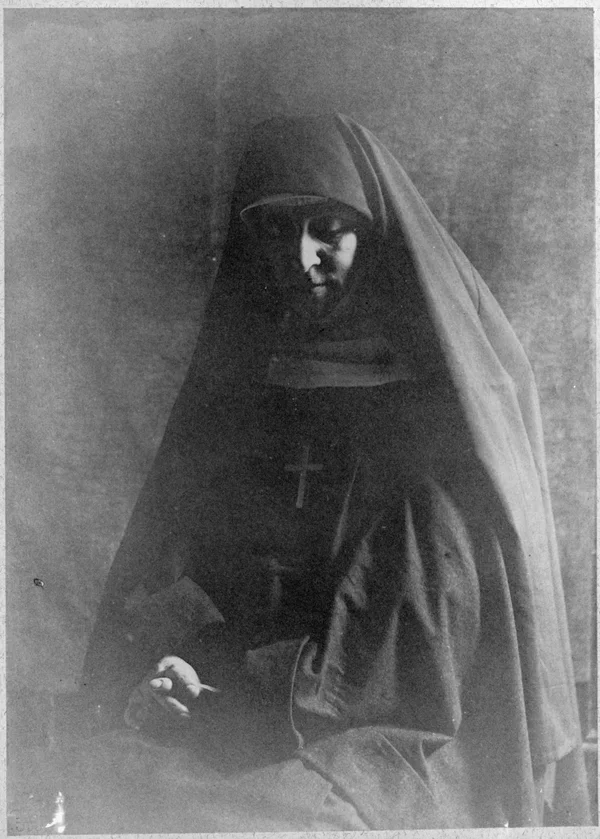 nun-hands-folded-praying-seated female