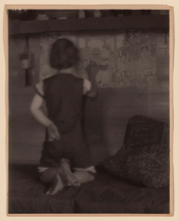 ruth-ruyl-shorts-divan-back-to-camera-examining-japanese-prints-wall female