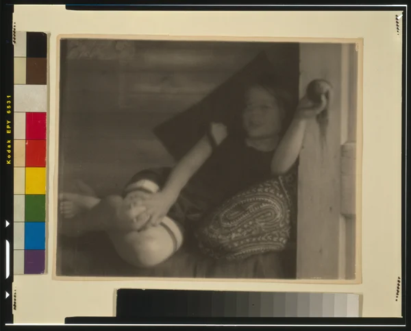 ruth-ruyl-shorts-divan-reclining-holding-doorknob-open-door female