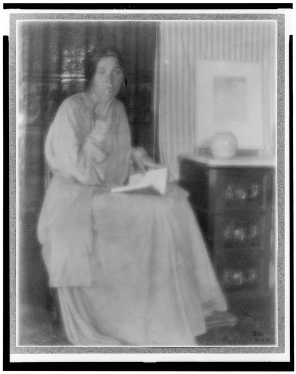 woman-beatrice-baxter-ruyl-dress-open-book-lap-hand-to-face-seated female