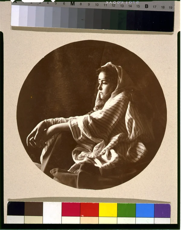 young-woman-middle-eastern-costume-jeweled-headband-seated-floor female