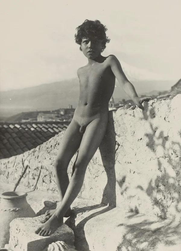 mano-sitting-nude-atop-wall male