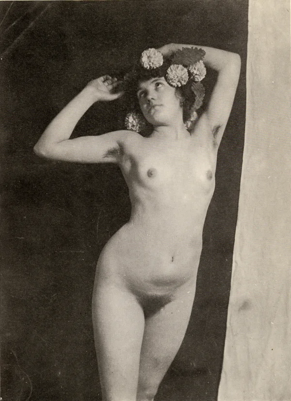 nude-woman-fecit-girl-full-body-pose-with-open-arms-and-flowers-on-head female