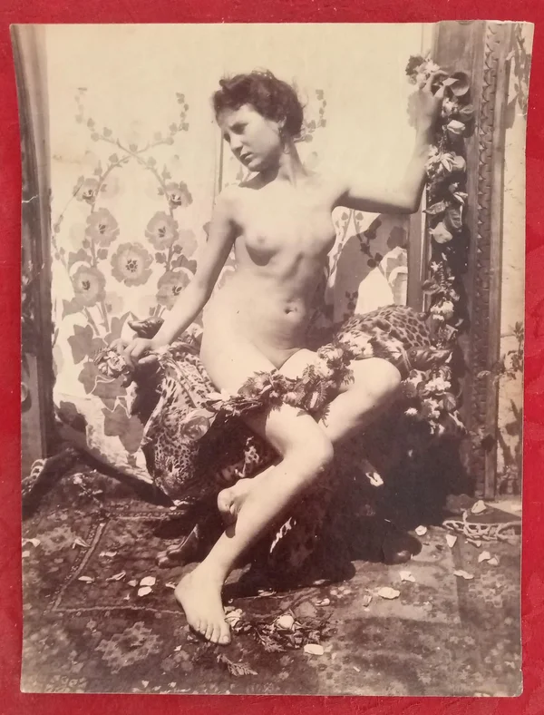 barebreasted-woman-on-stool-rugs-furs female