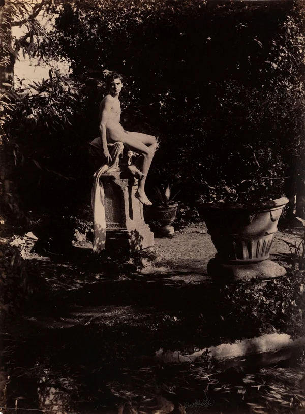 boy-seated-on-roman-capital-palazzo-colonna-garden male