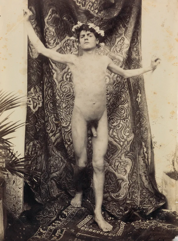 garlanded-youth-standing-before-relief-rug male