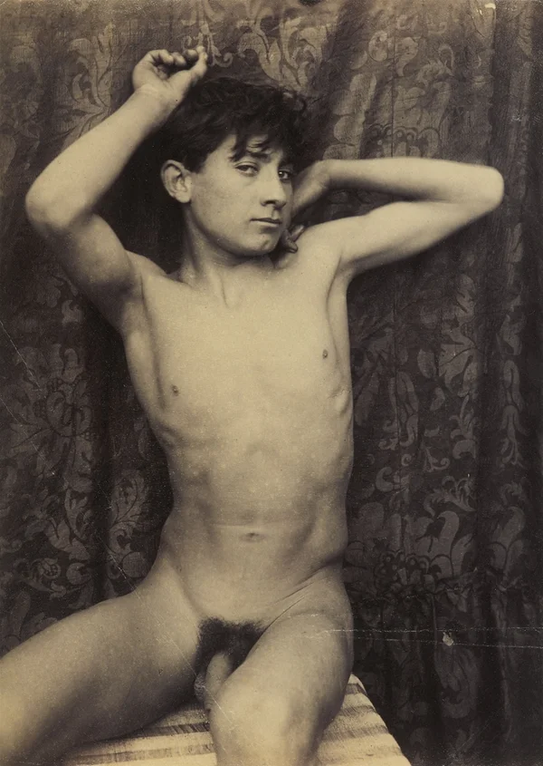 naked-boy-sitting-in-front-of-black-brocade-cloth male