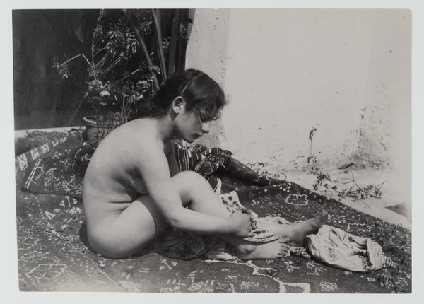 naked-woman-sitting-on-rug female