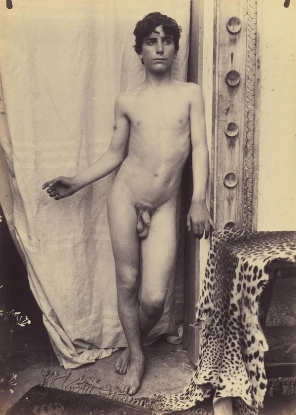 nude-boy-by-studded-doorframe male