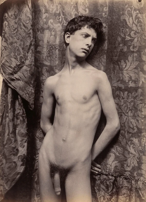 nude-youth-standing-arms-behind-back-leaning-against-damascus-cloth male