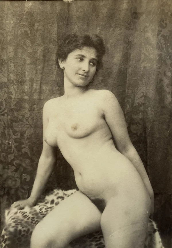 smiling-naked-woman-half-seated-before-brocade-cloth female