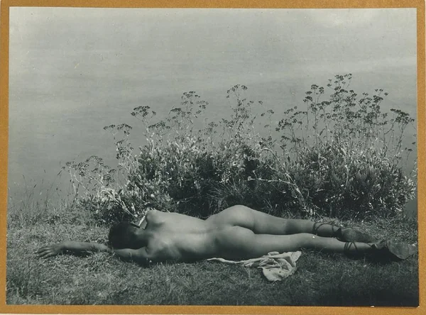 youth-leaning-on-lakeshore-from-behind male